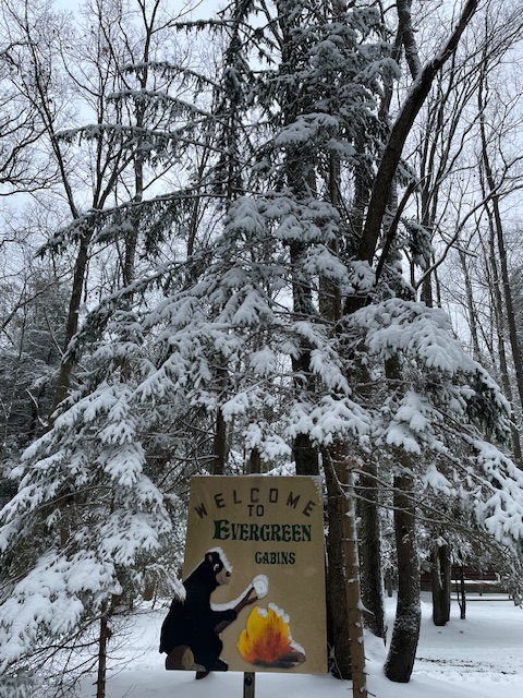 Evergreen Cabins snow winter sign